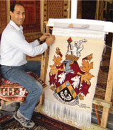Anas weaving the Coat of Arms at The Oriental Rug Gallery Ltd